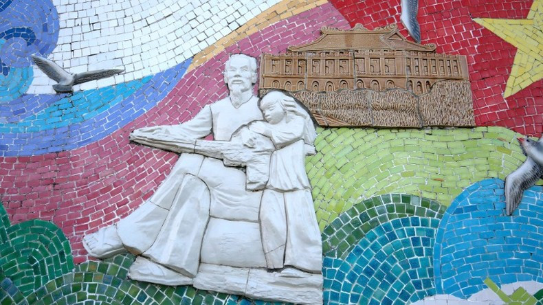 A ceramic mural of Uncle Ho with children.