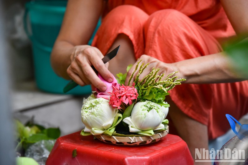 A seller is making a decorative item for her customers. A seller is making a decorative item for her customers.
