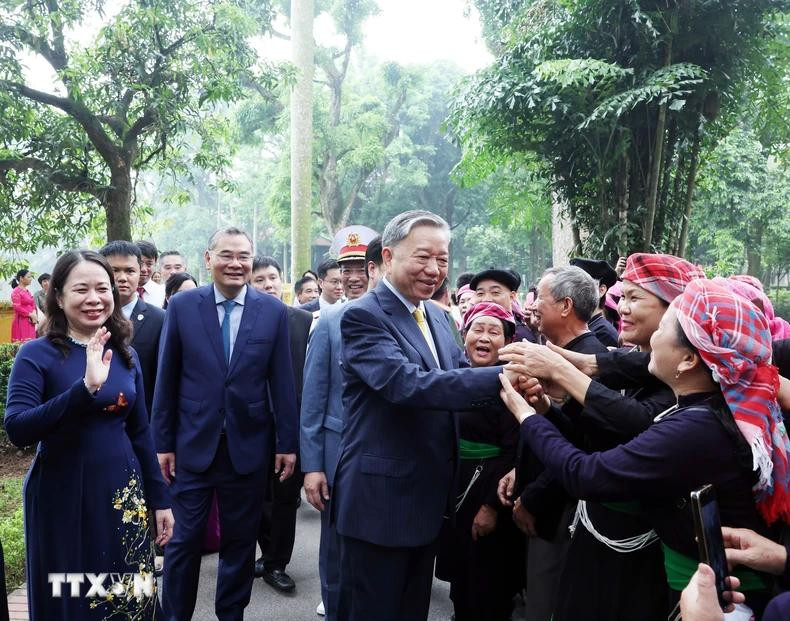 President To Lam shakes hands with people at the President Ho Chi Minh Relic Site.