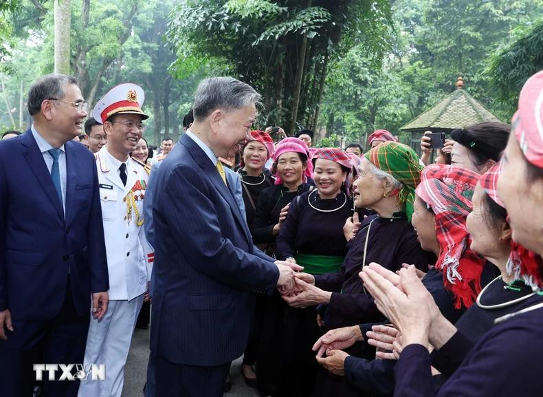 President To Lam shakes hands with people at the President Ho Chi Minh Relic Site.