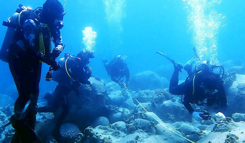 Divers measure and check coral reef recovery at Hon Mun.