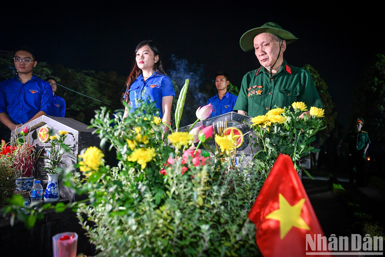 Relatives of martyrs are present at the cemetery to commemorate the fallen.