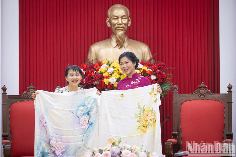 The two ladies pose for a photo.