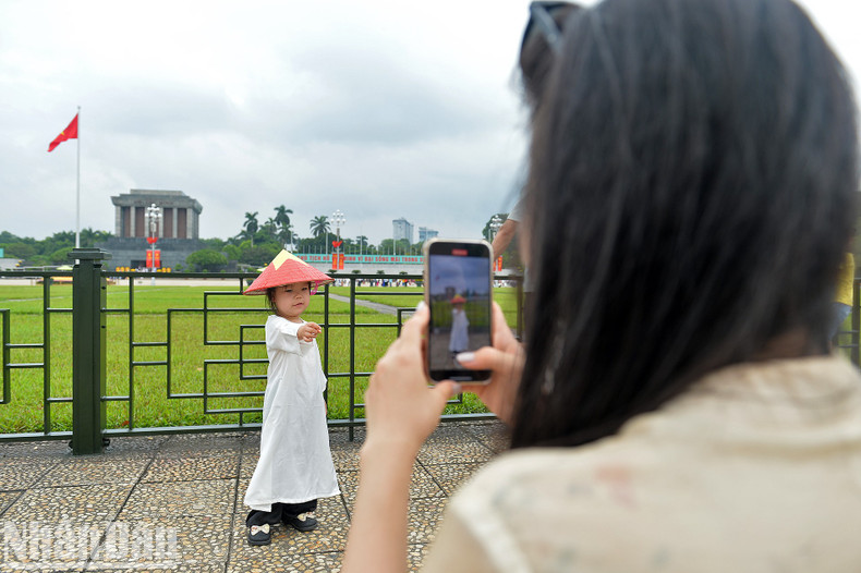 A little girl poses for a photo at Ba Dinh Square. A little girl poses for a photo at Ba Dinh Square.