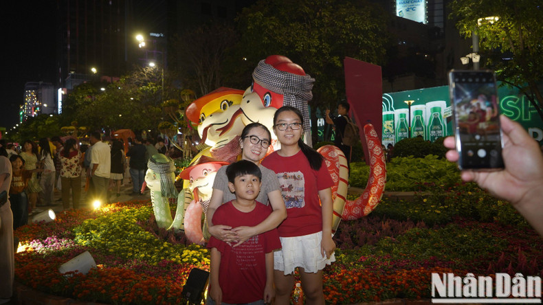 A family pose for a photo with cute snakes.