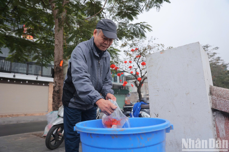 A resident releases fish into a container along West Lake. A resident releases fish into a container along West Lake.
