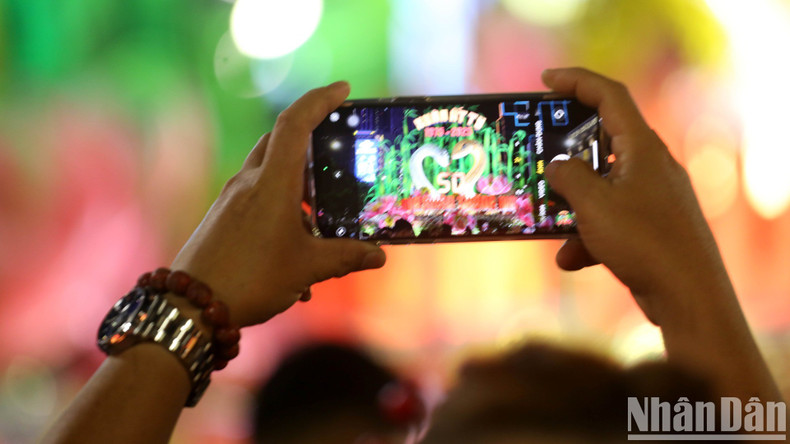 Visitors capture the flower street's memorable moments.