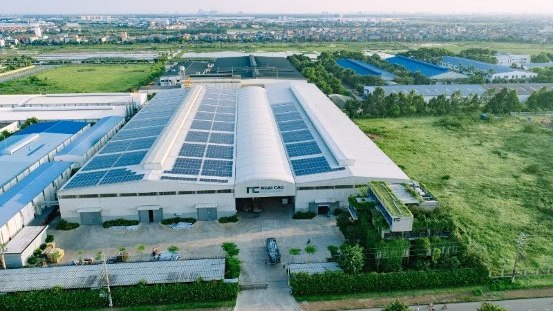 Rooftop solar panels are installed at a manufacturing facility to reduce electricity costs.