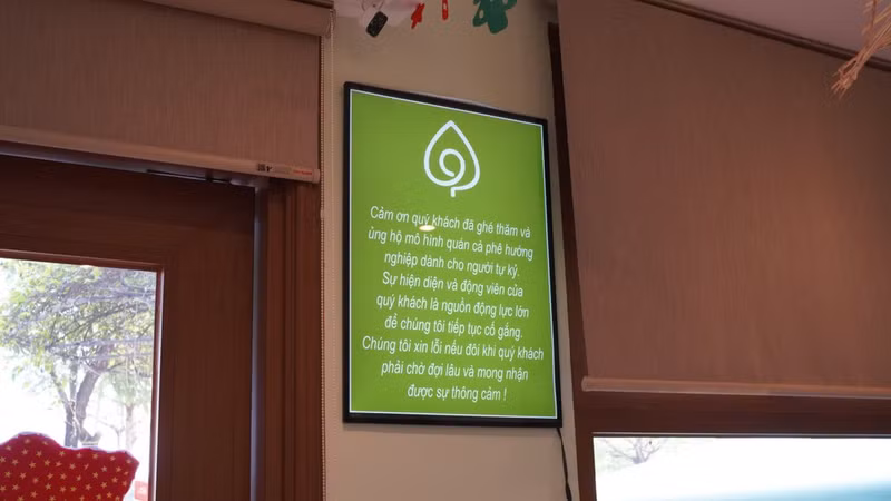 A message at the café introduces visitors to its inclusive mission.