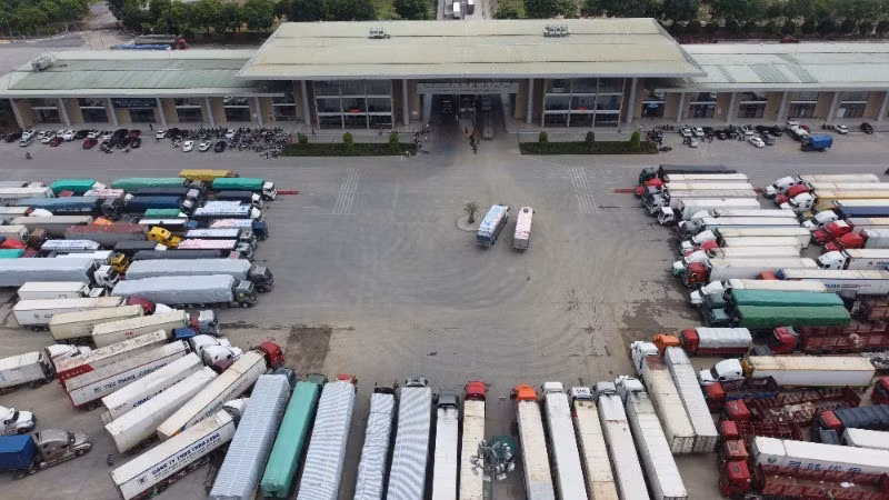Container trucks wait for customs clearance at Kim Thanh International Border Gate.