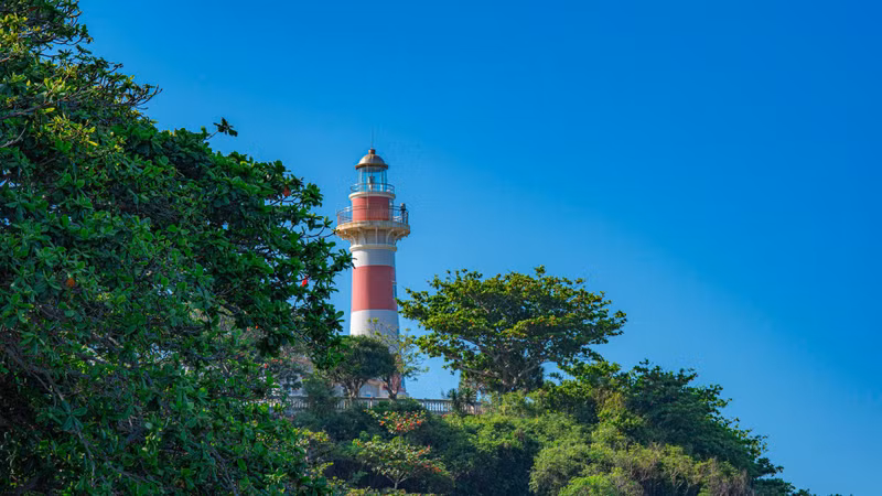 The lighthouse has a sturdy cylindrical structure, painted in vivid red and white, and rises more than 36 metres above sea level.