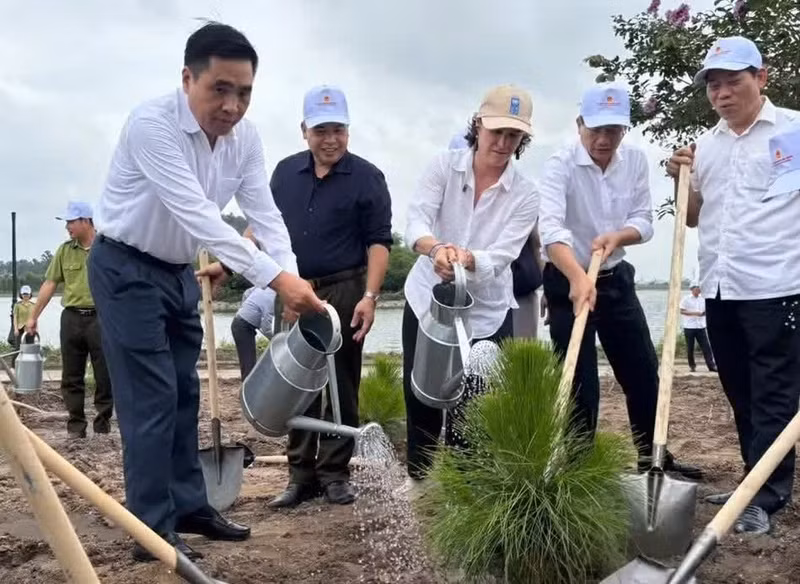 Delegates take part in a tree-planting activity at the event.