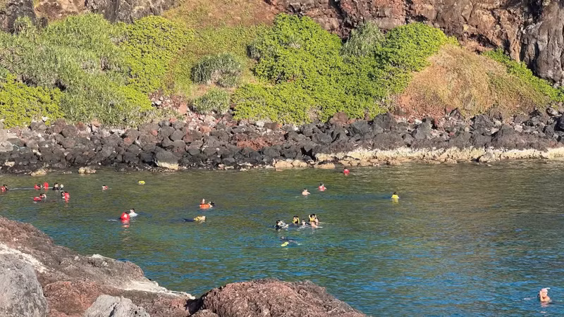 Tourists enjoy swimming at Hon Tranh Island.