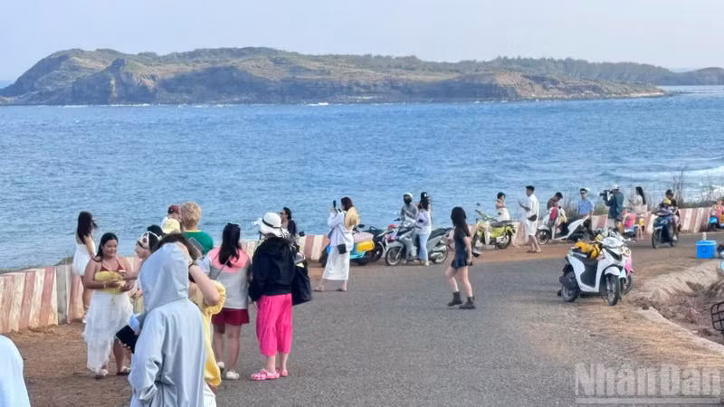 Visitors take photos on Phu Quy Island.