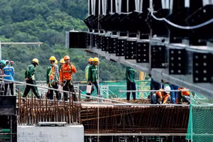 Workers at the construction site of the APEC Summit Centre.