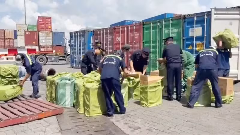 Customs officers inspect an imported shipment from Canada to Viet Nam containing smuggled cigarettes.