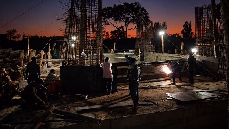 The contractors work overtime and carry out nighttime construction to accelerate the project completion schedule.