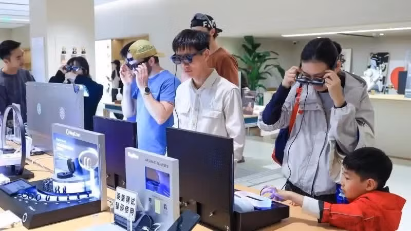 Customers try out smart glasses at a store in Shenzhen City, Guangdong Province, China. (Photo: Xinhua)