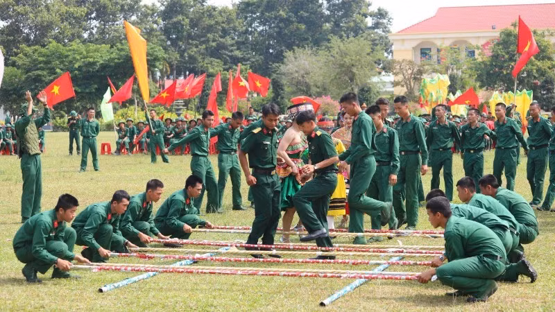Soldiers join in a traditional bamboo dance during a folk dance competition.