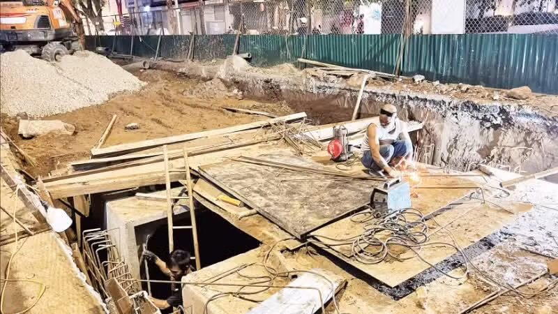 Contractors work overnight on flood-control projects in Ha Noi.