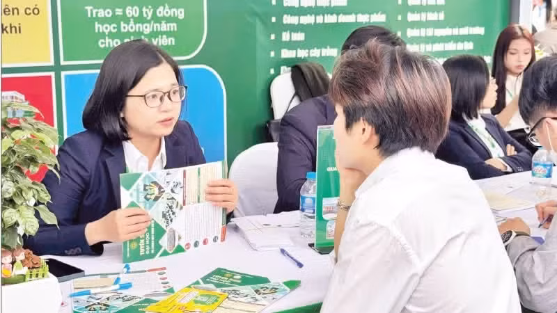 Students seek admissions information at a university admissions and career guidance event.