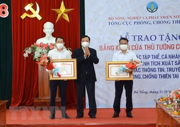 VNDMA General Director Tran Quang Hoai presents the PM's certificate of merit to leaders of the VNA bureau for the central and Central Highlands (Photo: VNA)