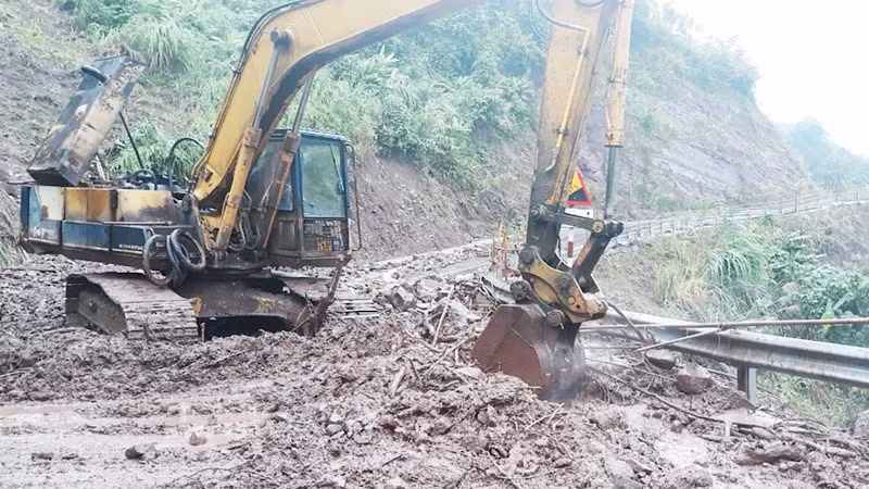 A road was being cleared to reach the landslide site.