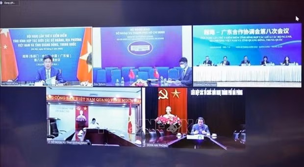 Vietnamese and Chinese officials take part in the teleconference on June 29. (Photo: VNA)