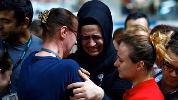 Airport employees mourn for their friends, who were killed in Tuesday's attack at the airport, during a ceremony at the international departure terminal of Ataturk airport in Istanbul, Turkey. (Credit: Reuters)
