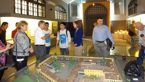 Two Hanoikids’ members (in white T-shirts) exchanging talks with US servicemen, including US General Herbert Carlisle, during a tour to Hoa Lo prison (Source: Hanoikids)