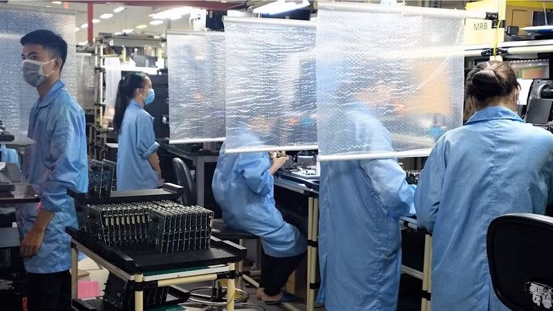Employees are working at Datalogic Vietnam company which is implementing “three on the spot” production model in the Ho Chi Minh City High-Tech Park.