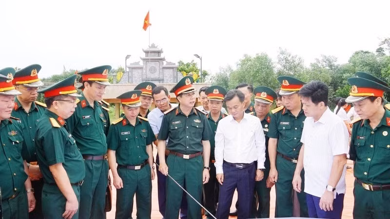 Leaders of Quang Tri Province and relevant agencies compare maps showing proposed survey locations for the search for martyrs’ remains in Cau Nhi area, Nam Hai Lang Commune.