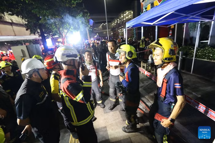 Rescuers gather at the scene after a fire broke out at a pub in Bangkok, Thailand, July 13, 2026. A fire at a pub near Lat Phrao Road in Bangkok's Chatuchak district killed 27 people and injured more than 10 others late Sunday, Thai media reported. The fire broke out at around 11:57 p.m. local time and was later extinguished. The injured were taken to hospitals for treatment. (Xinhua)