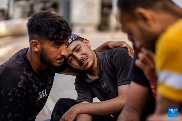 Palestinians mourn over victims killed in an Israeli airstrike, at Al-Shifa hospital in Gaza City, on June 14, 2026. Medical sources at the Gaza-based health authorities said on Sunday that the total death toll from the Israel-Hamas conflict in Gaza since Oct. 7, 2023, has surpassed 73,000. (Photo: Xinhua)