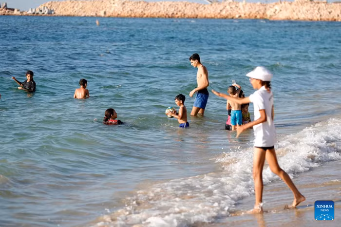 People cool off on a beach along the Mediterranean coast during a heatwave in Alexandria, Egypt, Aug. 22, 2026. (Xinhua)