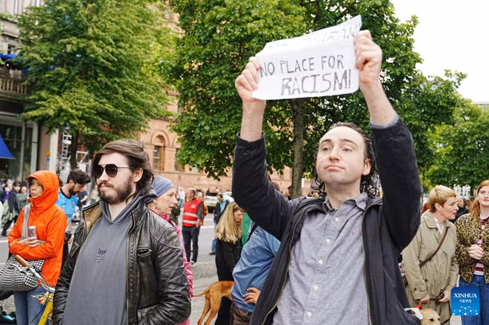 People holding signs attend an anti-racism rally in Belfast, Northern Ireland, the United Kingdom, June 13, 2026. Thousands of people gathered in central Belfast on Saturday for an anti-racism rally following days of disorder during which homes, businesses and vehicles were targeted. (Xinhua)