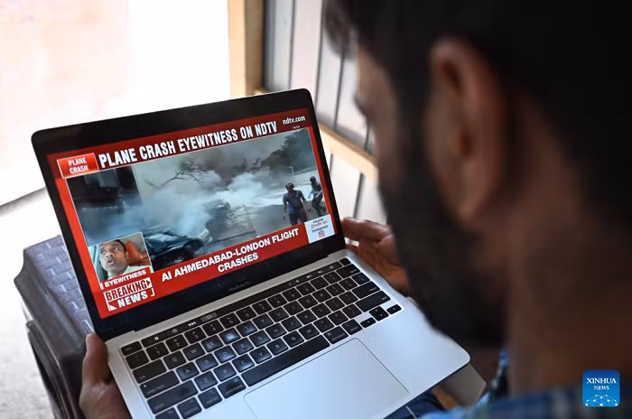 This photo taken in Srinagar, Indian-controlled Kashmir, shows a man watching the news of a plane crash in Ahmedabad of India's Gujarat state, June 12, 2025. An Air India flight to London crashed Thursday shortly after takeoff from an airport in the western Indian state of Gujarat, officials said. The flight with 242 people, including 230 passengers and 12 crew members, onboard took off from the Sardar Vallabhbhai Patel International Airport in Ahmedabad, about 17 km south of Gandhinagar, the capital city of Gujarat. (Photo: Xinhua)