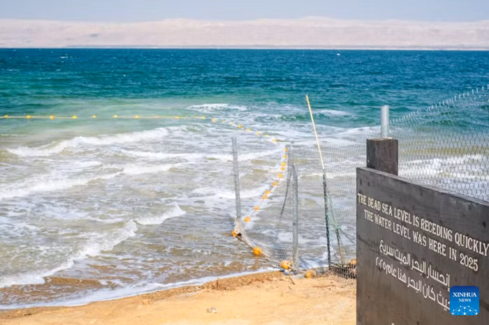 This photo taken on July 25, 2026 shows a sign marking the former water level near the Dead Sea in Jordan. The Dead Sea has been experiencing a long-term decline in its water level due to reduced inflow from the Jordan River, the region's naturally high evaporation rates, and industrial mineral extraction. Available data show that as of July 2026, the Dead Sea's surface was approximately 440 meters below sea level, and its water level has been declining by an average of more than one meter annually. (Xinhua)