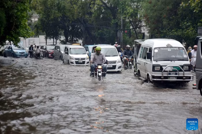 Vehicles move on a flooded street after heavy monsoon rains in Lahore, Pakistan, July 22, 2026. At least eight people were killed and 16 others injured in rain-related incidents across Pakistan over the past 24 hours as monsoon showers continued to batter parts of the country, the National Disaster Management Authority said on Tuesday. (Photo: Xinhua)