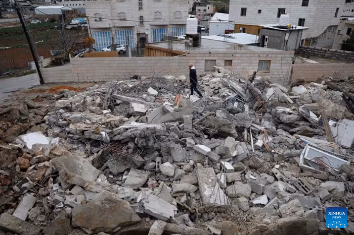 A Palestinian checks the rubble of a house demolished by the Israeli forces in the city of Hebron, southern West Bank, on Jan. 15, 2026. Israeli authorities arrested 80 Palestinians, demolished a house, and barred the Palestinian Authority's minister of Jerusalem affairs from entering the West Bank, according to Palestinian sources on Thursday. (Photo: Xinhua)
