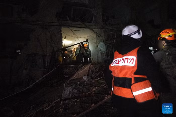 Emergency responders work at an impact site of an Iranian missile attack in Dimona, southern Israel, March 21, 2026. A missile fired from Iran injured 47 people in the southern Israeli city of Dimona on Saturday night, including a 10-year-old boy in serious condition, according to Israel's national emergency service Magen David Adom (MDA). (Israel Defense Forces/Handout via Xinhua)