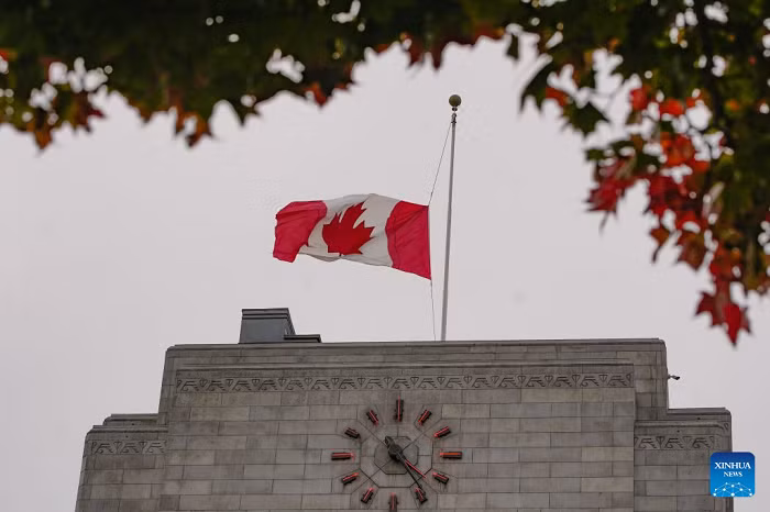 A Canadian national flag flies at half-mast outside a municipal government building in Vancouver, British Columbia, Canada, on Oct. 18, 2026. Canadian government announced on Sunday that flags at federal government buildings across the country would be flown at half-mast to mourn the deaths of four people in a major fire that broke out Saturday at a military base in the western province of Alberta. (Photo: Xinhua)