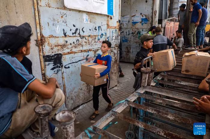 Palestinians receive food rations through the World Food Programme from one of its distribution centers in the Al-Tuffah area east of Gaza City, on Sept. 15, 2026. (Photo: Xinhua)