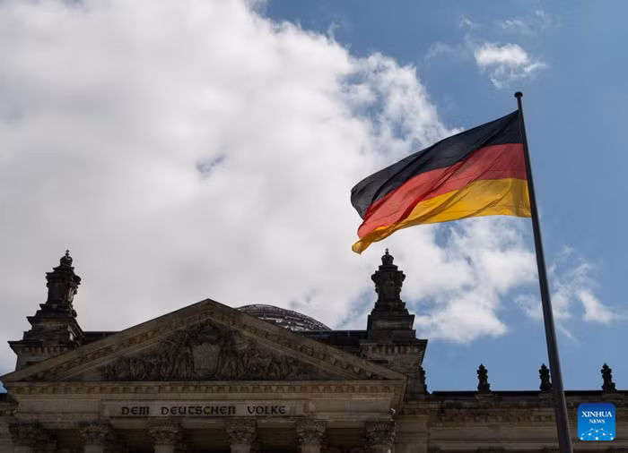 This photo taken on July 24, 2026 shows a German national flag outside the Reichstag building in Berlin, Germany. German Chancellor Friedrich Merz on Friday announced a major reshuffle of his cabinet, highlighted by the appointment of Nina Warken as the new Chancellery head and Carsten Linnemann as the health minister. (Xinhua)