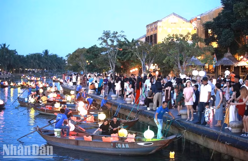 Tourists participate in releasing flower lanterns on the Hoai River (Hoi An). (Photo: Dinh Tang)
