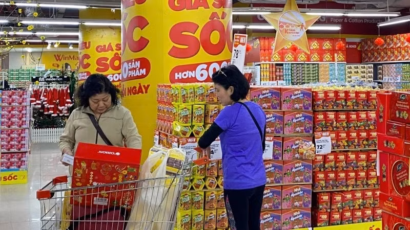 Consumers shop at Winmart Royal City supermarket in Hanoi.