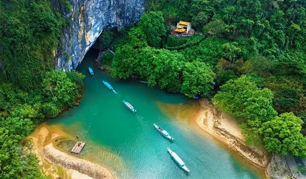 Tourists explore Phong Nha Cave by boat (Photo: VNA)