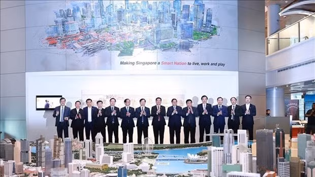 Prime Minister Pham Minh Chinh and officials visit the Singapore Smart National Exhibition. (Photo: VNA) 