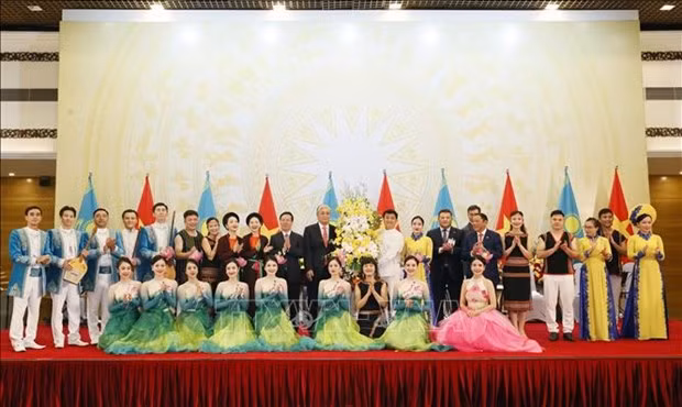 Vietnamese President Vo Van Thuong and Kazakh President Kassym-Jomart Tokayev present flowers to artists who perform at the banquet. (Photo: VNA)