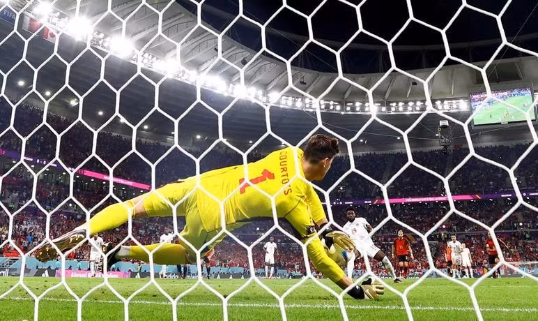 Canada's Alphonso Davies has his penalty saved by Belgium's Thibaut Courtois. (Photo: Reuters)